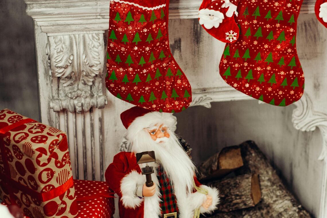 A cozy Christmas scene featuring Santa and festive stockings by a fireplace.